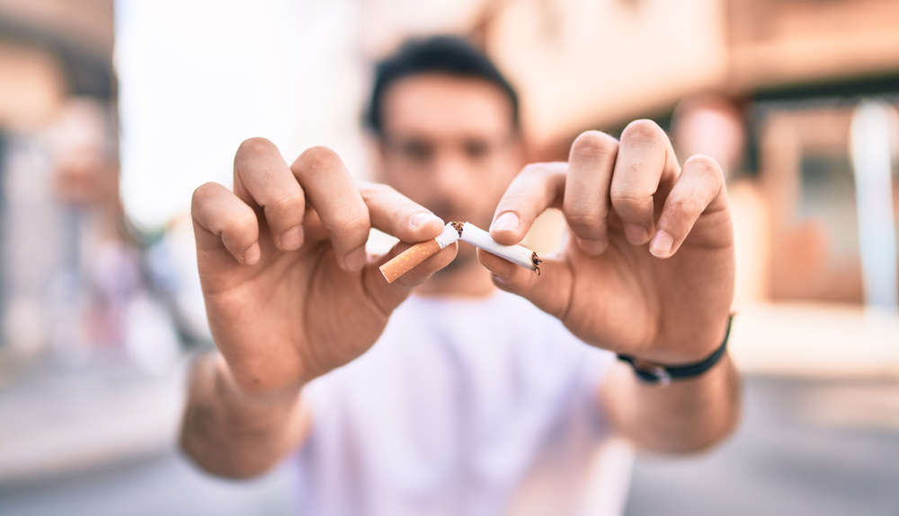 A person breaking cigarette